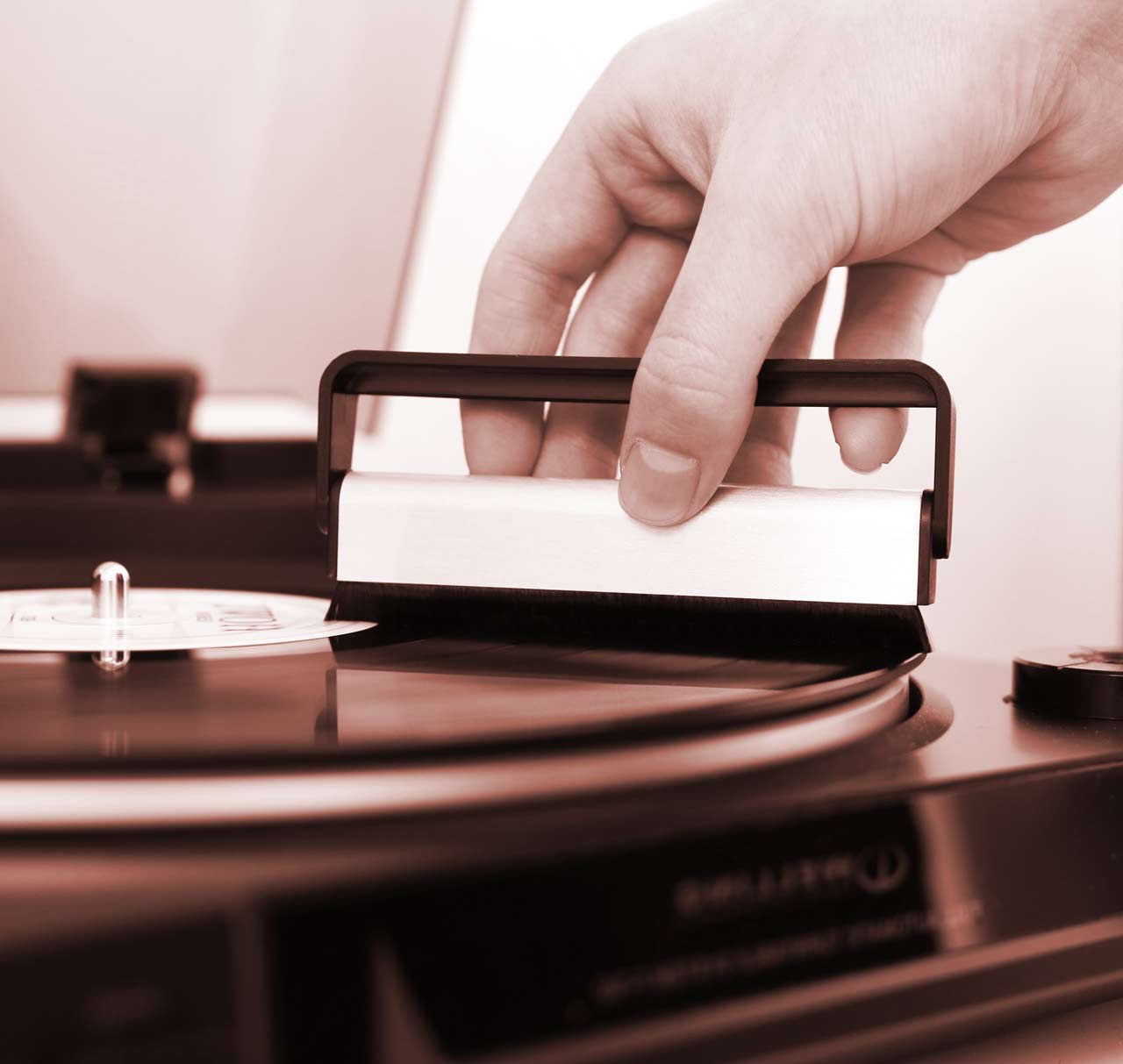 An image of somebody cleaning dust off their vinyl record. Copyright Nicholas Dempsey 2017.